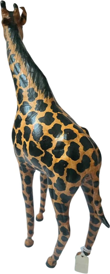 Giraffe figurine with a tag on a white background